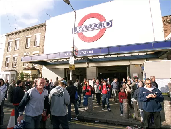 Arsenal fans walk outside Arsenal Tube Station before the match