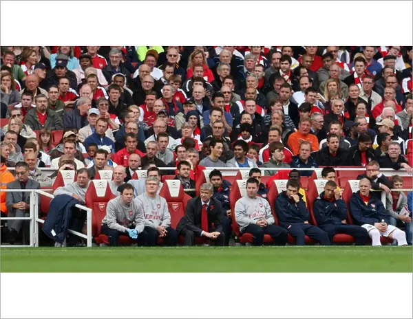 Arsene Wenger the Arsenal Manager seats in the dug