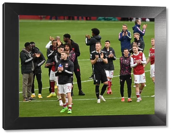 Arsenal Clinches Premier League Title: Bernd Leno Celebrates with Fans after Victory over Brighton