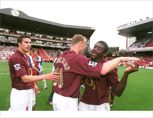 Robin van Persie, Dennis Bergkamp and Kolo Toure celebrate at the end of the match