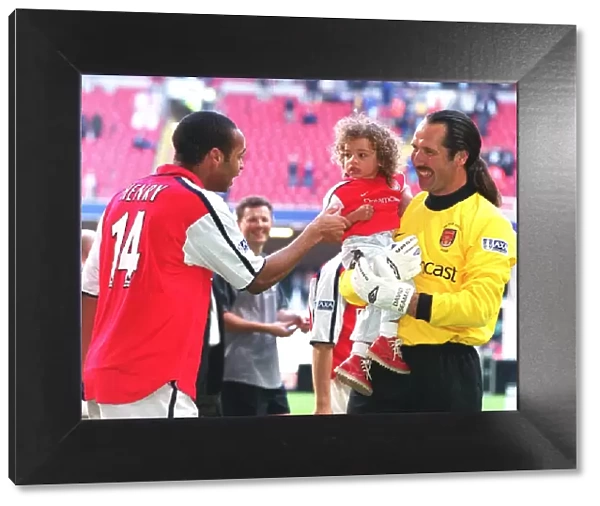 Arsenal goalkeeper David Seaman with daughter Georgina and Thierry Henry after the match