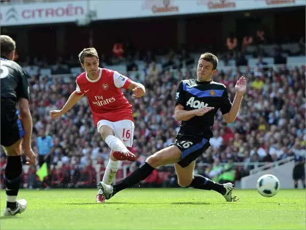 Aaron Ramsey scores Arsenals goal past Michael Carrick (Man Utd). Arsenal 1