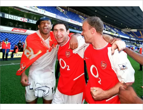 Thierry Henry, Martin Keown and Dennis Bergkamp (Arsenal) celebrate winning the league