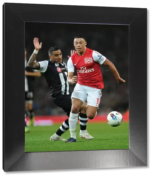 Arsenal's Alex Oxlade-Chamberlain Outmaneuvers Newcastle's Danny Simpson in Premier League Clash (Arsenal v Newcastle United, 2011-12)