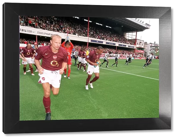 Dennis Bergkamp and Thierry Henry (Arsenal) run out at the start of the match