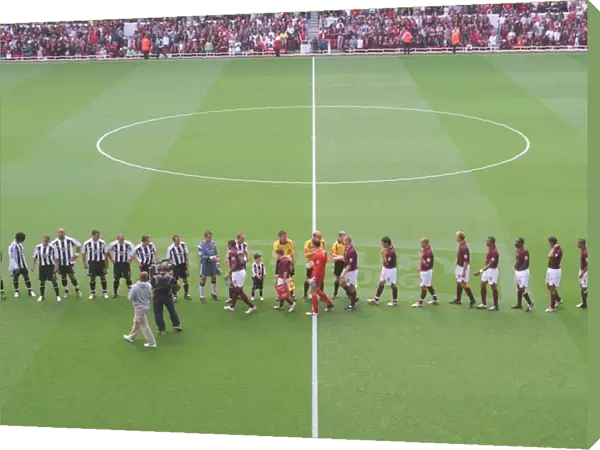 The Arsenal and Newcastle team shake hands before the match