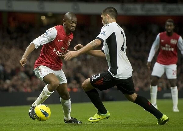 Abou Diaby of Arsenal takes on Clint Dempsey of Fulham during the Barclays Premier League match between Arsenal and Fulham at Emirates Stadium on November 26, 2011 in London, England. Credit; Arsenal