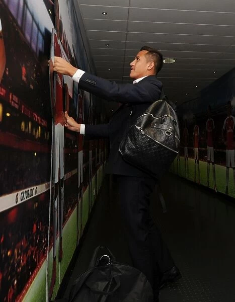 Alexis Sanchez Contemplates Self-Portrait Cutout before Arsenal vs. Stoke City Match (2015-16)