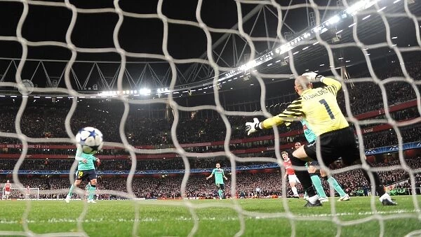 Andrey Arshavin shoots past Barcelona goalkeeper Victor Valdes to score the 2nd Arsenal goal