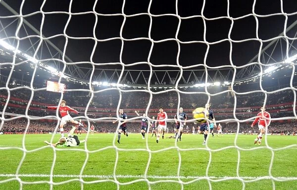 Andrey Arshavin shoots past Bolton goalkeeper Jussi Jskelainen to score the 4th Arsenal goal