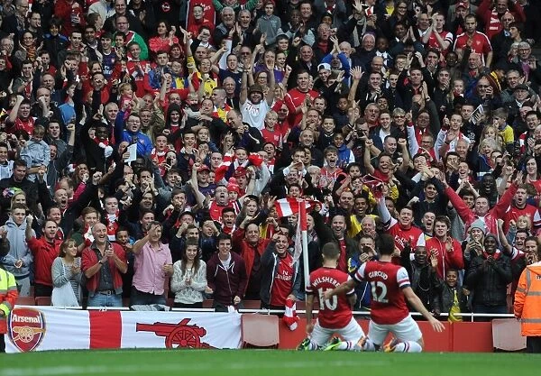 Arsenal fans celebrate the 1st goal scored by Jack Wilshere. Arsenal 4: 1 Norwich City