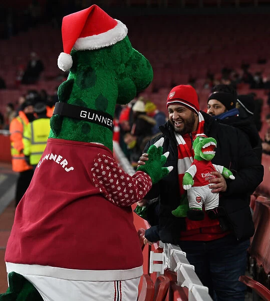 Arsenal FC: Gunnersaurus Statue Amidst Fans Electric Excitement at Carabao Cup Quarterfinal, Emirates Stadium