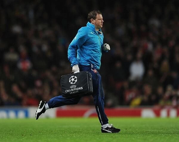 Arsenal FC vs RSC Anderlecht: Colin Lewin Tends to Injured Player in UEFA Champions League Match, Emirates Stadium, London, 2014