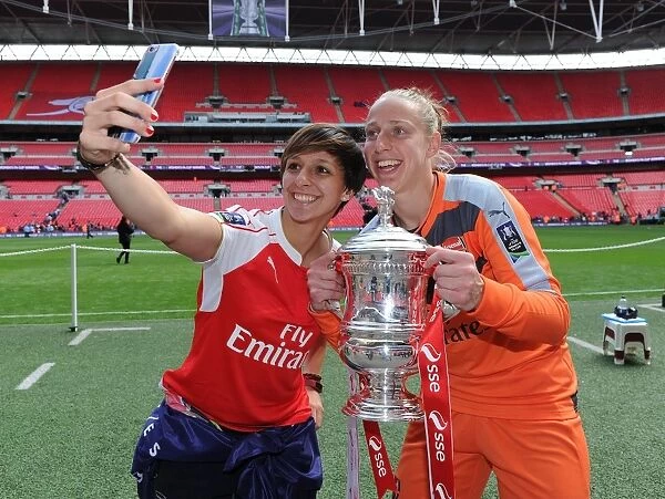 Arsenal Ladies Celebrate FA Cup Victory: Marta Corredera and Sari van Veenendaal Triumph with the Trophy