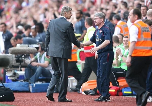 Arsenal manager Arsene Wenger and assistant Pat Rice shake hands after the match