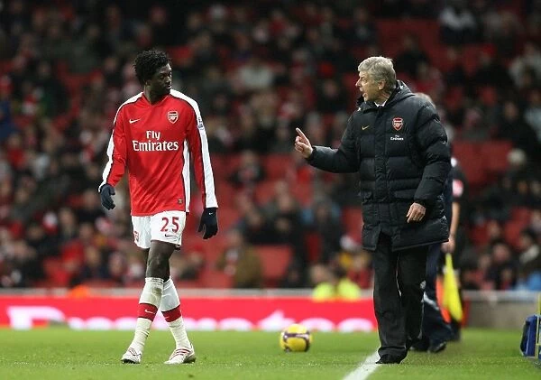 Arsenal manager Arsene Wenger talks with Emmanuel Adebayor