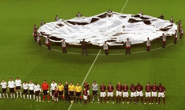 The Arsenal team line up before the match with the Champions League banner behind them