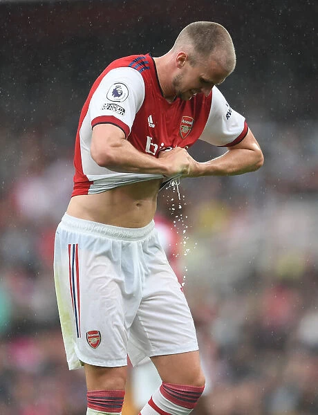 Arsenal vs. Chelsea: Rob Holding Wrings Out Drenched Shirt Amidst Premier League Downpour (2021-22)
