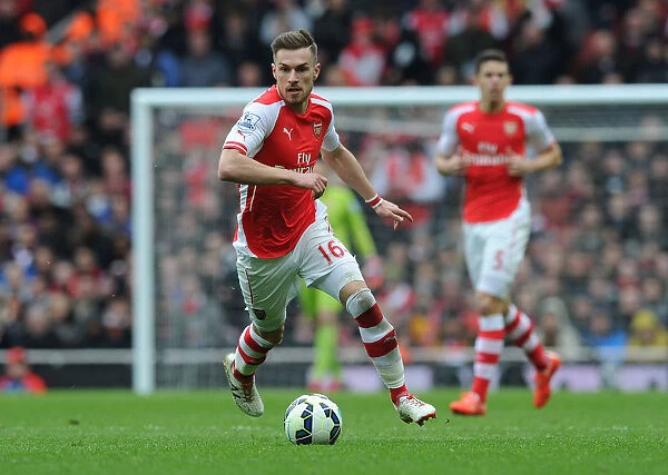Arsenal vs. Liverpool: Aaron Ramsey's Intense Action in the 2014-15 Premier League Clash at Emirates Stadium