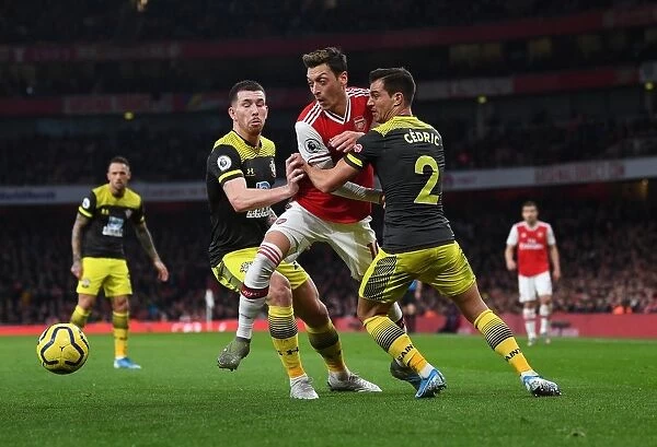 Arsenal vs Southampton: Ozil Faces Off Against Hojbjerg and Cedric