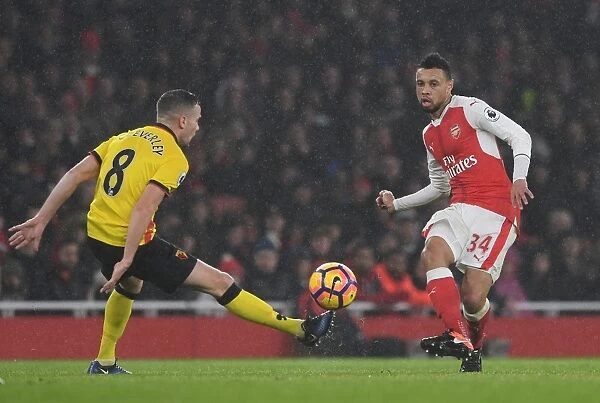 Arsenal vs. Watford: Coquelin Evades Cleverley's Pressure in Premier League Clash