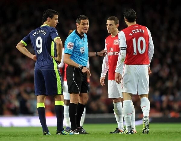 Arsenal vs. Wigan: Referee Andre Mariner Mediates Between Vermaelen, van Persie, and Di Santo