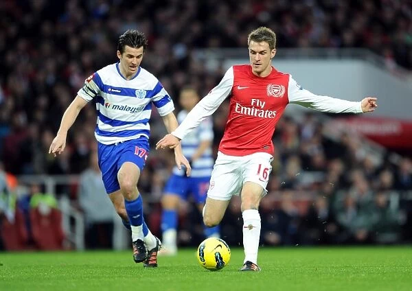 Arsenal's Aaron Ramsey Clashes with QPR's Joey Barton during Premier League Match