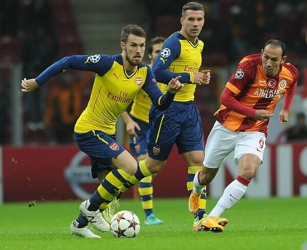 Arsenal's Aaron Ramsey Faces Off Against Galatasaray's Umut Bulut in UEFA Champions League Clash