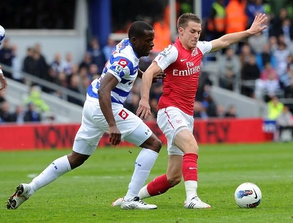 Arsenal's Aaron Ramsey Faces Off Against Nedum Onuoha in Intense Queens Park Rangers Clash