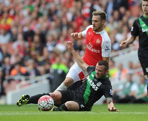 Arsenal's Aaron Ramsey Faces Off Against Phil Bardsley in Intense Premier League Clash