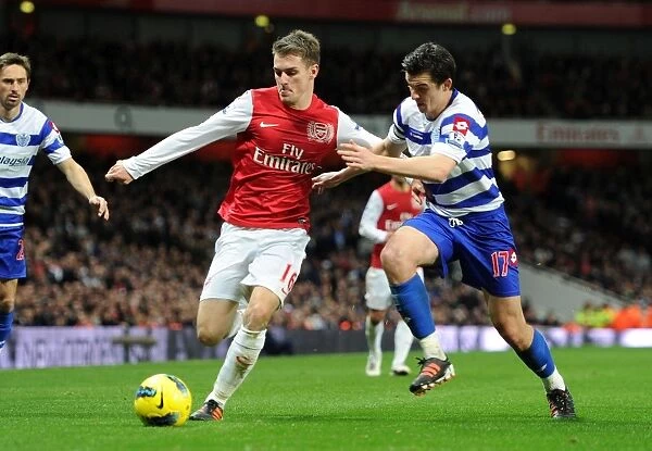 Arsenal's Aaron Ramsey Fends Off Joey Barton during the 2011-12 Premier League Clash