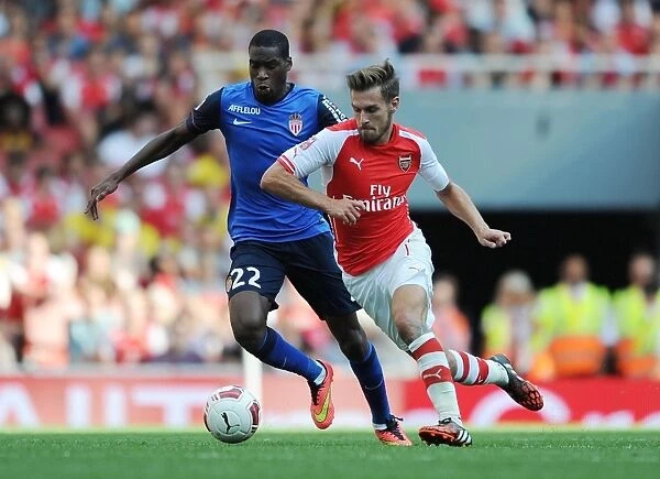 Arsenal's Aaron Ramsey Outmaneuvers AS Monaco's Geoffrey Kondogbia during the Emirates Cup Match