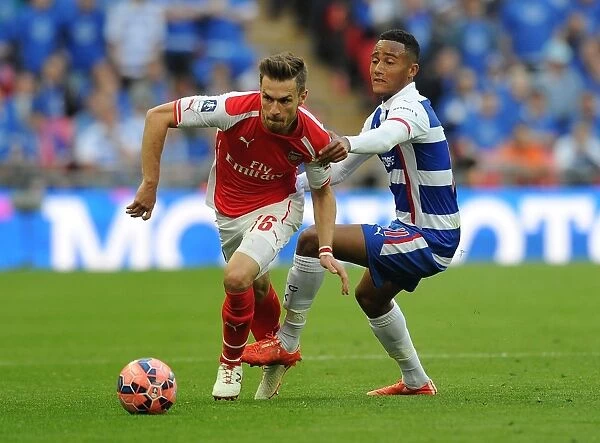 Arsenal's Aaron Ramsey Outmaneuvers Reading's Jordan Obita in FA Cup Semi-Final Clash
