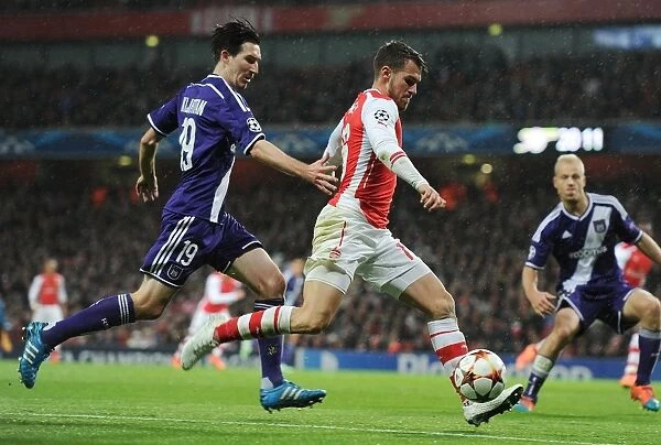 Arsenal's Aaron Ramsey Outmaneuvers Sacha Kljestan in Champions League Clash