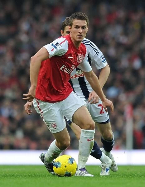 Arsenal's Aaron Ramsey Outmaneuvers West Brom's Zoltan Gera