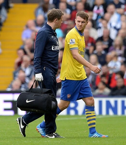 Arsenal's Aaron Ramsey Receives Treatment from Physio Colin Lewin during West Bromwich Albion Match