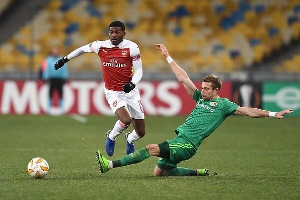 Arsenal's Ainsley Maitland-Niles Faces Off Against Vorskla Poltava's Lurii Kolomoets in Europa League Clash