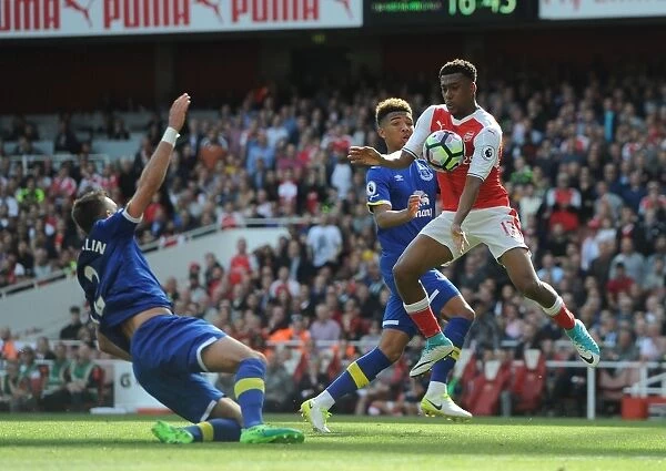 Arsenal's Alex Iwobi Faces Off Against Everton Duo Mason Holgate and Morgan Schneiderlin