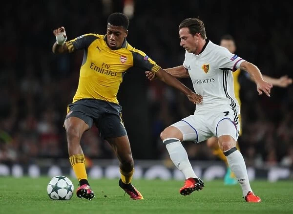 Arsenal's Alex Iwobi Faces Off Against FC Basel's Luca Lang in 2016-17 UEFA Champions League Clash