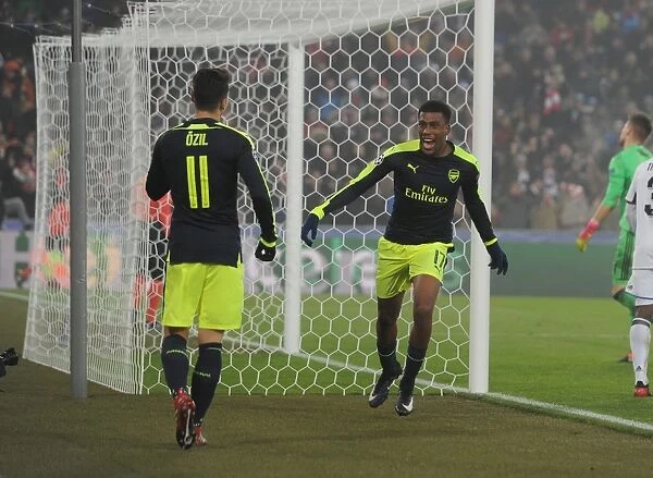 Arsenal's Alex Iwobi and Mesut Ozil Celebrate Goals Against FC Basel in 2016-17 UEFA Champions League