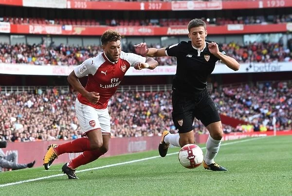Arsenal's Alex Oxlade-Chamberlain Faces Off Against Sevilla's Sebastien Corchia at the Emirates Cup