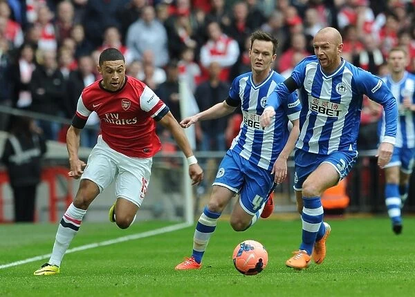 Arsenal's Alex Oxlade-Chamberlain Stands Off Against Wigan's Stephen Crainey and Josh McEachran in FA Cup Semi-Final Clash
