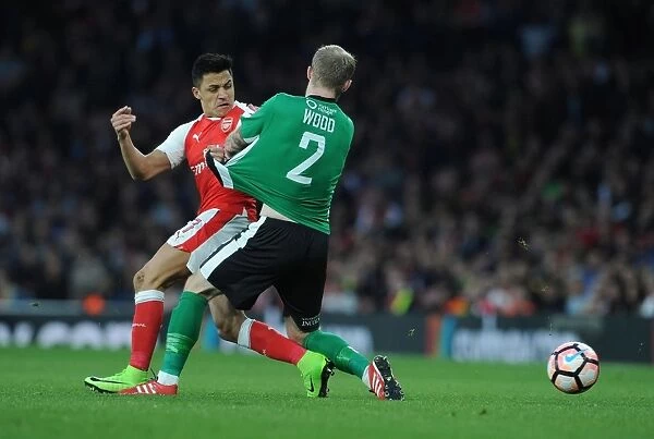 Arsenal's Alexis Sanchez Clashes with Lincoln's Bradley Wood in FA Cup Quarter-Final