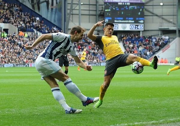 Arsenal's Alexis Sanchez Closes In on West Brom's Craig Dawson in Intense Premier League Clash