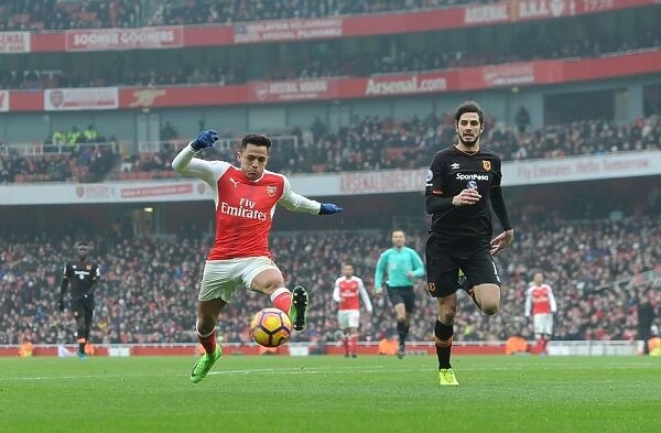 Arsenal's Alexis Sanchez Fends Off Hull's Andrea Ranocchia During Premier League Clash