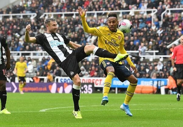 Arsenal's Aubameyang Faces Off Against Newcastle's Dummett in Premier League Clash