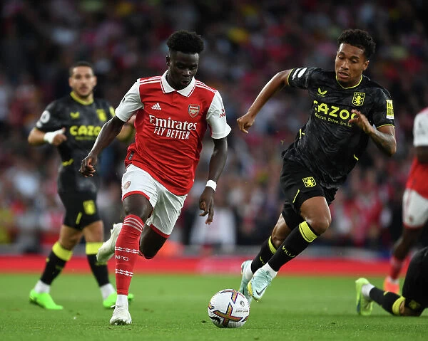 Arsenal's Bukayo Saka Clashes with Aston Villa's Jacob Ramsey in 2022-23 Premier League Showdown