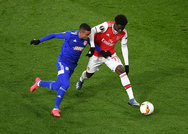 Arsenal's Bukayo Saka Clashes with Olympiacos Bruno Gaspar in Europa League Showdown