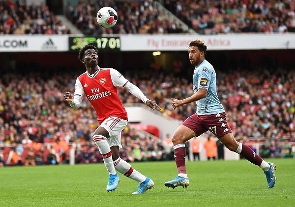Arsenal's Bukayo Saka Faces Off Against Aston Villa's Trezeguet in Intense Premier League Clash