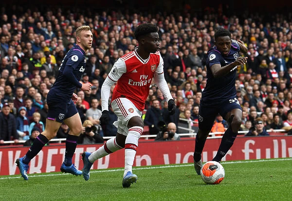 Arsenal's Bukayo Saka Faces Off Against West Ham's Jeremy Ngakia in Premier League Clash